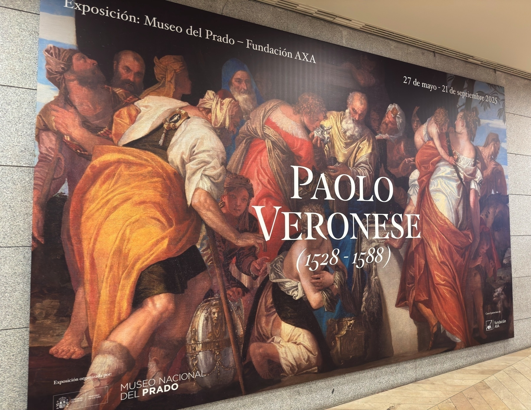 Large exhibition banner for “Paolo Veronese (1528–1588)” displayed on an exterior wall of the museum. The banner shows a detail from one of Veronese’s paintings, with richly dressed figures in dramatic poses rendered in warm tones. Exhibition dates are listed as May 27 to September 21, 2025, and the organizing institutions are noted at the bottom.