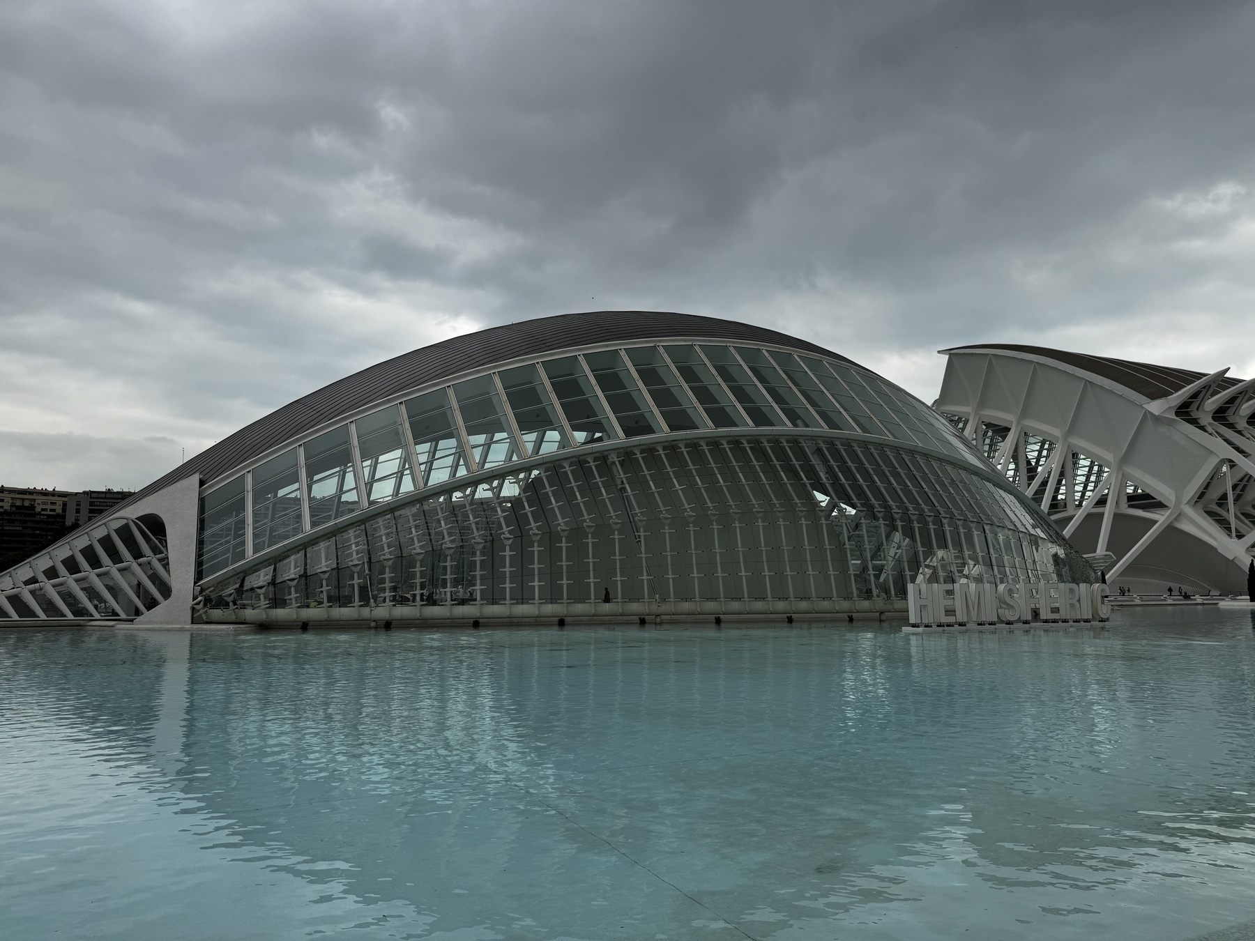The L’Hemisfèric in Valencia’s City of Arts and Sciences, shaped like a giant eyelid, appears to float on a pool of blue water—its symmetry and reflection enhancing the building’s biomorphic design.