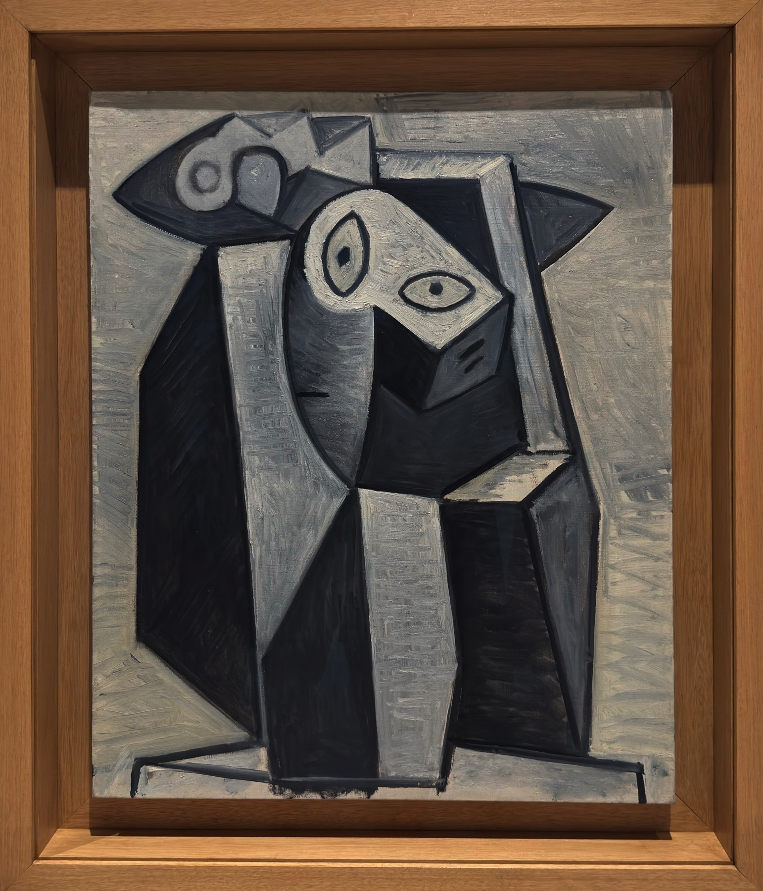 A geometric, Cubist head of a woman painted in monochromatic blues and grays. This late work showcases Picasso’s mature Cubist language, where the face is fractured into sculptural forms that suggest depth and emotion through abstraction. The palette and angular construction lend the figure a statuesque solemnity, illustrating his ability to blend analytical Cubism with psychological expression.
